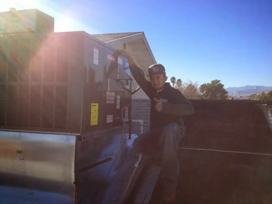 HVAC technician performing Boiler Repair on a rooftop unit in Wyoming